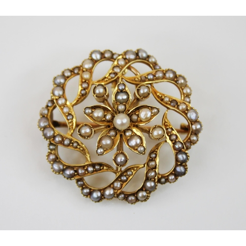 237 - A Victorian seed pearl set pendant brooch, designed as a central pearl set flower head, within a pie... 