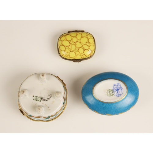 268 - A selection of three enamelled pill boxes, to include a Limoges oval example, florally decorated aga... 