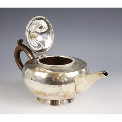 46 - A George V silver teapot, Hukin and Heath Ltd, Birmingham 1924, of compressed globular form on raise... 