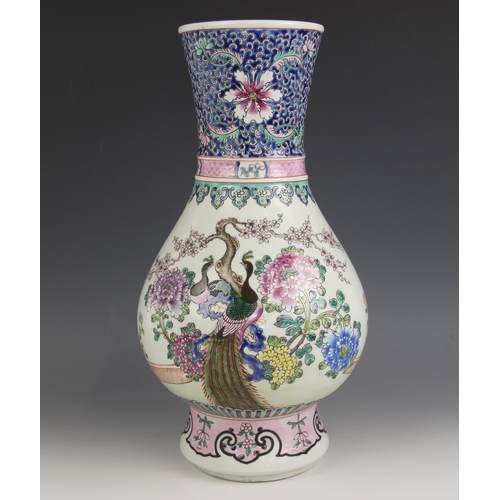 572 - A Chinese porcelain famille rose 'Peacock' vase, Kangxi six character mark, painted with two peacock... 