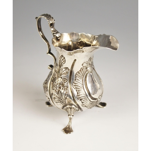 61 - A Victorian silver cream jug, 'W.H', London 1844, of baluster form with scroll handle and ogee rim, ... 