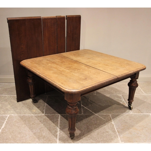 820 - A Victorian oak extending dining table, the rectangular moulded top with rounded corners, upon inver... 