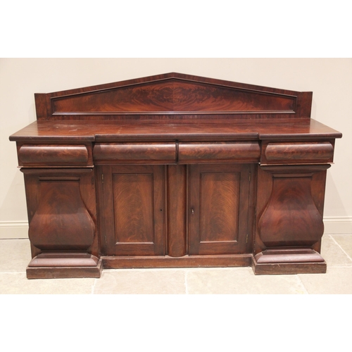 823 - A mid 19th century inverted breakfront sideboard, the architectural raised back over three cushion m... 