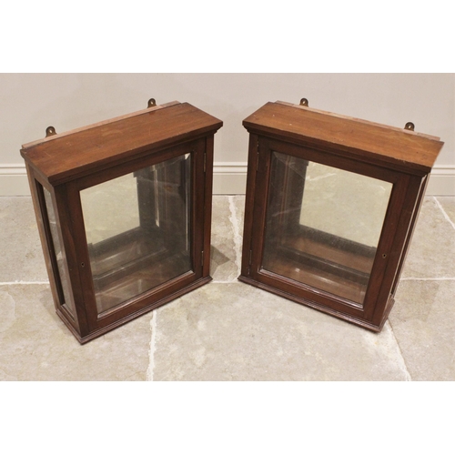 827 - A pair of Victorian walnut wall hanging display cases, each with a moulded cornice over a single bev... 