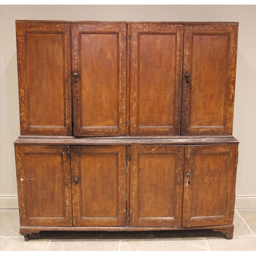 834 - A 19th century scumbled pine housekeepers cupboard, formed with an arrangement of four cupboard door... 