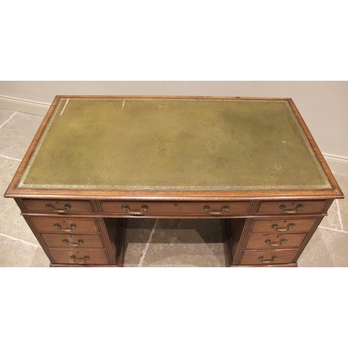 839 - An Edwardian mahogany twin pedestal writing desk, the rectangular moulded top inset with a green lea... 