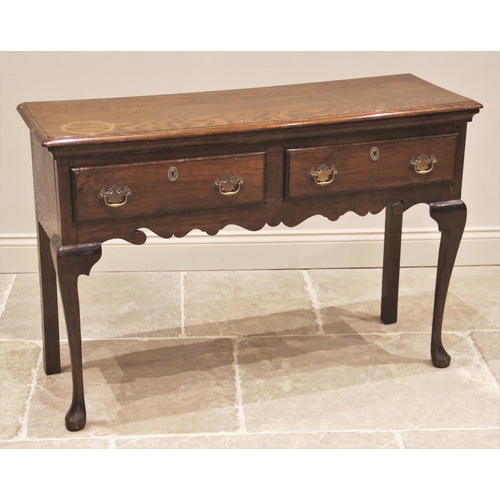 851 - An 18th century style oak dresser, early 20th century, the high back with a moulded cornice over a s... 