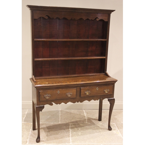 851 - An 18th century style oak dresser, early 20th century, the high back with a moulded cornice over a s... 