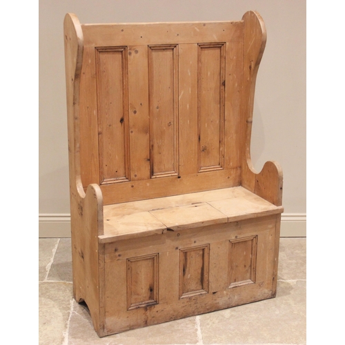 852 - A 17th century style pine box settle, 20th century, the shaped wing backs united by a panelled back ... 