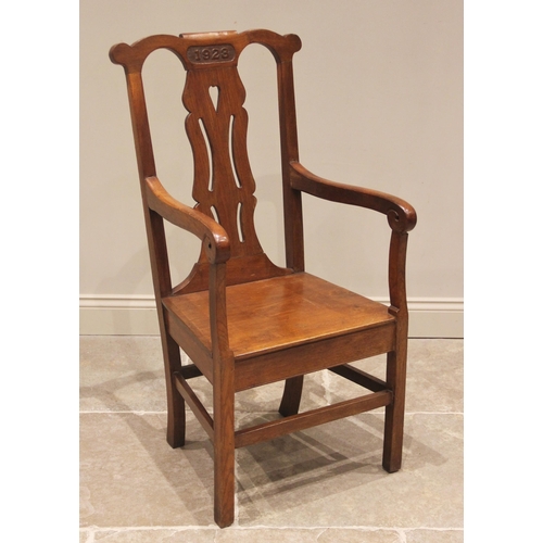 854 - A 1923 oak Eisteddfod chair, the top rail carved with the year above a pierced splat and board seat,... 