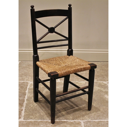 855 - An ebonised beech wood child's chair in the manner of William Morris, circa 1900, the 'X' frame rail... 