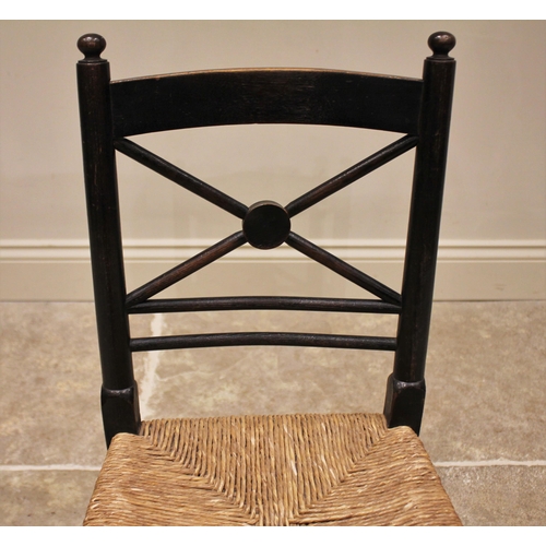 855 - An ebonised beech wood child's chair in the manner of William Morris, circa 1900, the 'X' frame rail... 