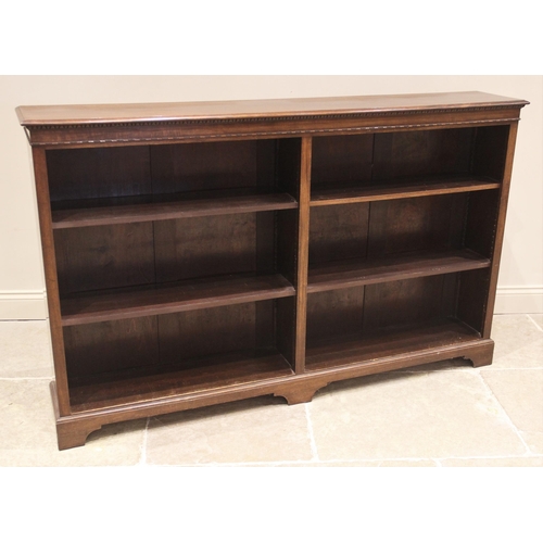 860 - An early 20th century mahogany open bookcase, the rectangular moulded top above a beaded frieze and ... 