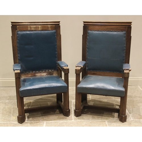 862 - A pair of teak and leather magistrates court throne chairs, early 20th century, each with a moulded ... 