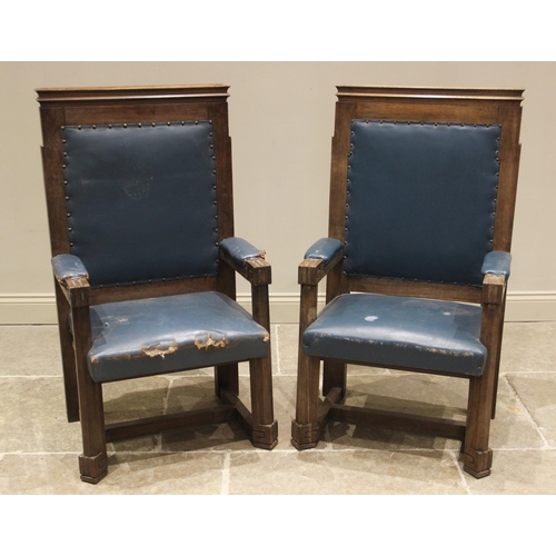 864 - A pair of teak and leather magistrates court throne chairs, early 20th century, each with a moulded ... 