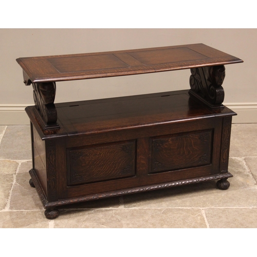 869 - A 17th century style oak monks bench, 20th century, the panelled tilt top upon supports carved with ... 