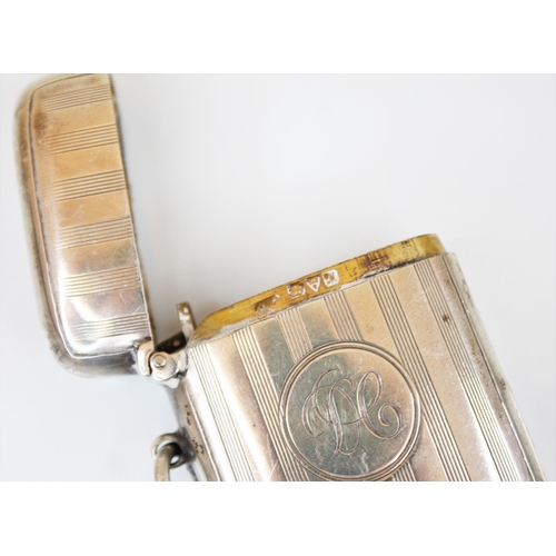 89 - A George V silver vesta case, Chester 1912, the rectangular body with engine turned decoration and c... 