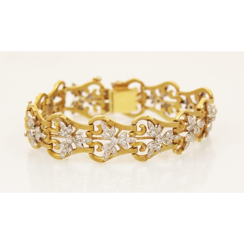 155 - A diamond set bracelet, designed as a row of pierced gold coloured lyre shaped links, with twelve ap... 