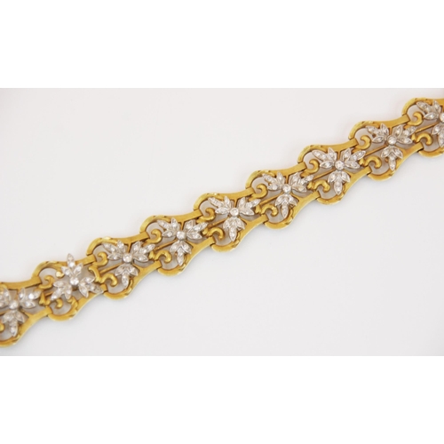 155 - A diamond set bracelet, designed as a row of pierced gold coloured lyre shaped links, with twelve ap... 