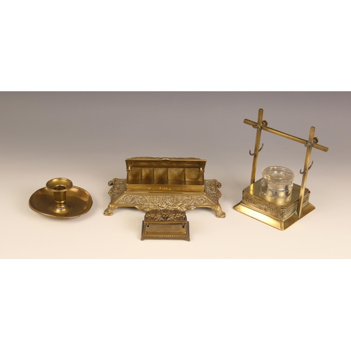 665 - A brass desk tidy, early 20th century, cast in relief with neo-classical urns and scrolls, the hinge... 