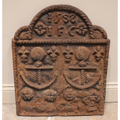 671 - A cast iron fireback, of break arch form, cast in relief with year 1588, the initials 'I.F.C', two a... 