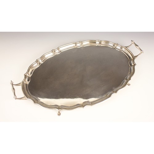 3 - A George VI twin handled silver tray, Barker Brothers Silver Ltd, Birmingham 1939, the oval tray wit... 