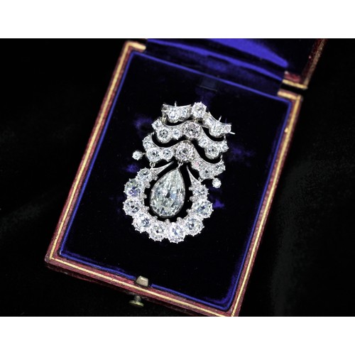 201 - An early 20th century diamond drop pendant brooch, the central pear cut diamond weighing an estimate... 