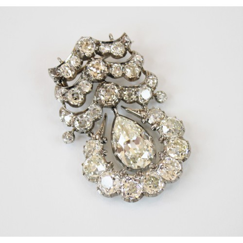 201 - An early 20th century diamond drop pendant brooch, the central pear cut diamond weighing an estimate... 