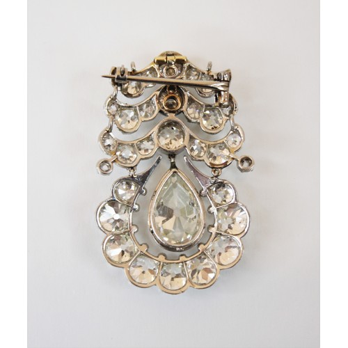 201 - An early 20th century diamond drop pendant brooch, the central pear cut diamond weighing an estimate... 