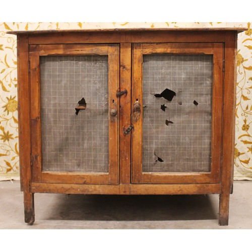 831 - A Victorian pine food hutch, the board top above mesh side panels and a pair of doors, upon stile fe... 