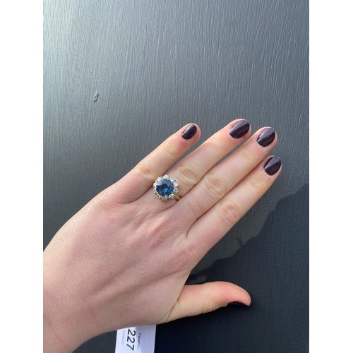 227 - A sapphire and diamond ring, the round cut sapphire weighing 5.10 carats approx. (10.7 x 10.7 x 6.0 ... 