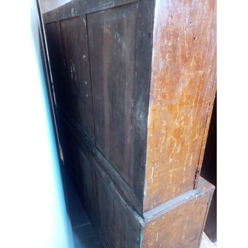 834 - A 19th century scumbled pine housekeepers cupboard, formed with an arrangement of four cupboard door... 