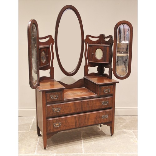 826 - A Victorian walnut dressing chest, the back with triple mirrors and two mirrored cabinets, over two ... 