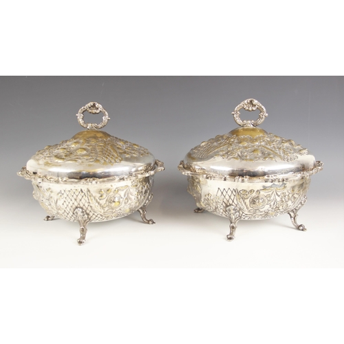 138 - A pair of Walker & Hall silver plated serving dishes and covers, each with circular body embossed wi... 