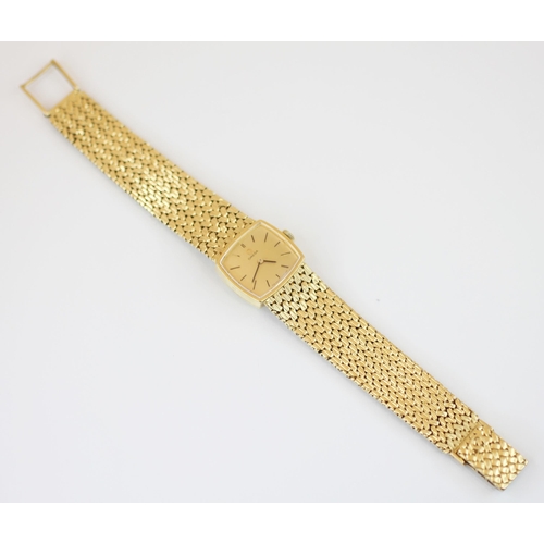 151 - An 18ct gold Omega lady’s wristwatch, the square champagne colour dial with baton markers, set to a ... 