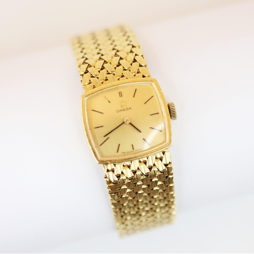 151 - An 18ct gold Omega lady’s wristwatch, the square champagne colour dial with baton markers, set to a ... 