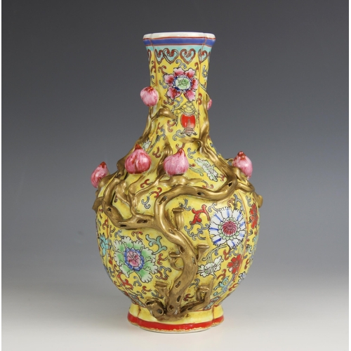 428 - A Chinese porcelain yellow ground Magnolia vase, Qianlong seal mark, the bottle shaped tri-lobed vas... 