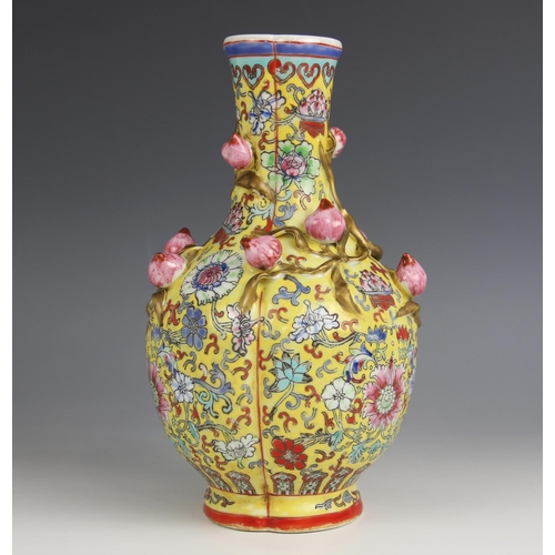 428 - A Chinese porcelain yellow ground Magnolia vase, Qianlong seal mark, the bottle shaped tri-lobed vas... 