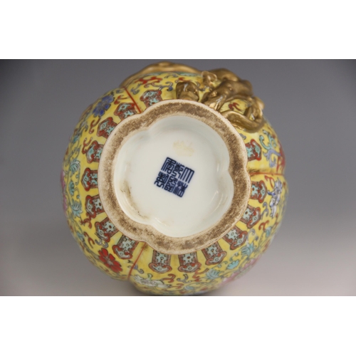 428 - A Chinese porcelain yellow ground Magnolia vase, Qianlong seal mark, the bottle shaped tri-lobed vas... 