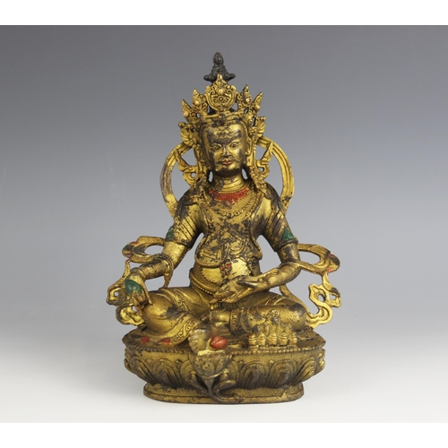 430A - A South East Asian gilt model of Jambhala, modelled seated with the right hand grasping a bijapuraka... 