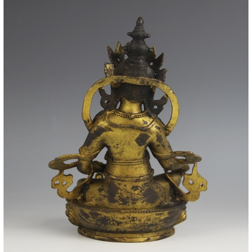 430A - A South East Asian gilt model of Jambhala, modelled seated with the right hand grasping a bijapuraka... 