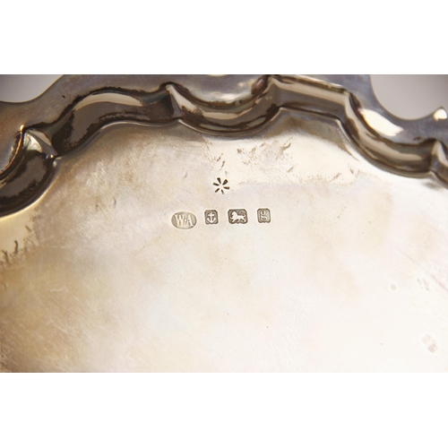 45 - An Edwardian silver salver, William Aitken, Birmingham 1906, with moulded border, upon three scroll ... 