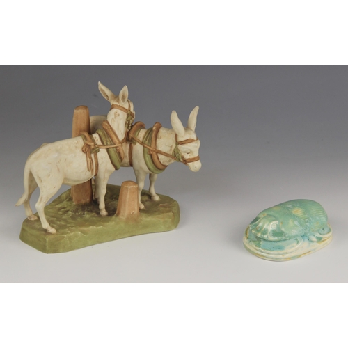 462 - A Royal Dux model 1111 donkey group, early 20th century, modelled as two harnessed donkeys, one lean... 