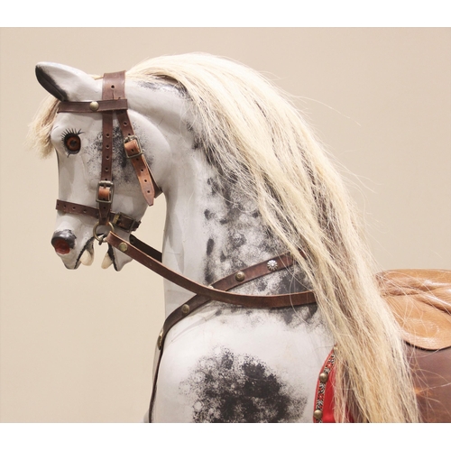 557 - A dapple grey 'coach sprung' rocking horse in the manner of F H Ayres, early 20th century, modelled ... 