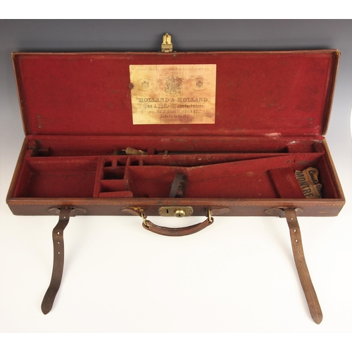 561 - A Holland & Holland leather bound wooden gun case with brass sprung catch and leather over-strap, th... 