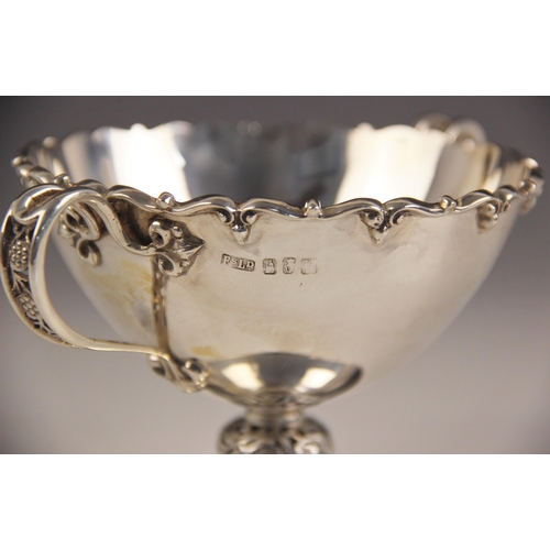 62 - A George V silver cased two handled bowl and spoon, Finnigans Ltd, Dublin 1912, the bowl with cast s... 