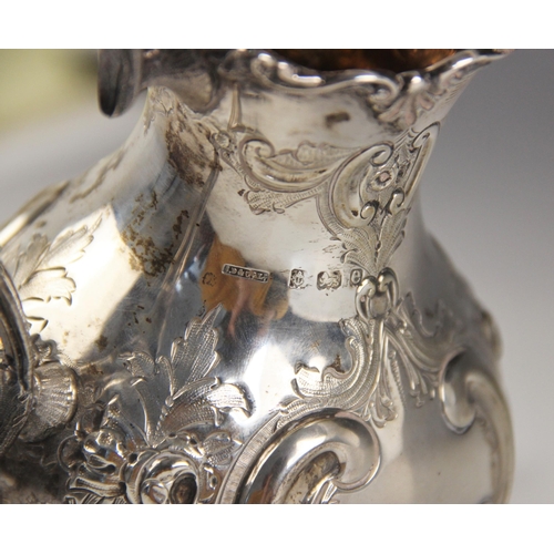 71 - An Edwardian silver milk jug, Johnson, Durban and Co Ltd, Birmingham 1904, the cast scrolling rim ab... 