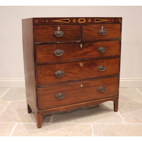 766 - An early 19th century mahogany chest of drawers, the inlaid frieze over an arrangement of two short ... 