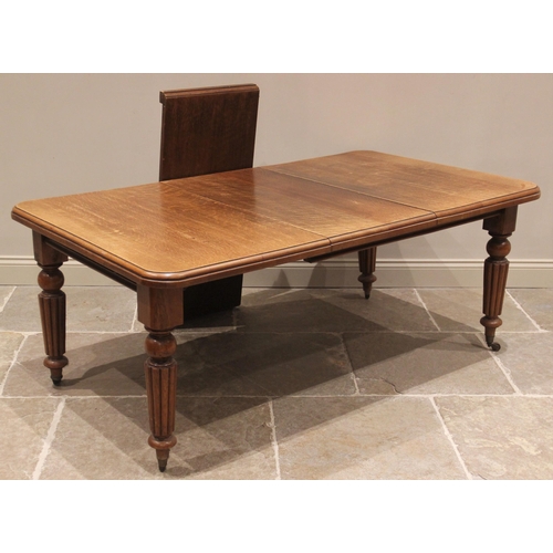 776 - A Victorian oak extending dining table, the rectangular top with moulded and rounded corners upon lo... 