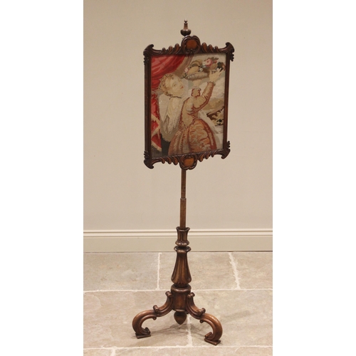 777 - An early Victorian walnut pole screen, the needlework panel glazed within a carved swept frame, upon... 